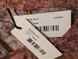 a close up of a label on a dress on a hanger