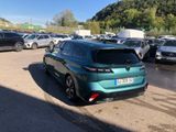 a green car parked in a parking lot with other cars