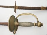 two different types of swords on display on a table