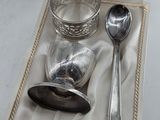 a silver spoon, spoon and spoon rest in a box