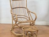 a wicker rocking chair and a small table on the floor