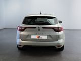 the rear end of a silver car in a white room
