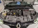 the engine of a car with its hood open in a showroom