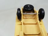 a yellow toy car that is being held up by a person