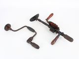 an image of a pair of old fashioned fishing reels on a white surface