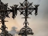 pair of antique metal candlesticks with ornate designs on them