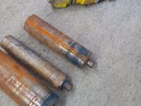 four cylinders that are laying on the floor