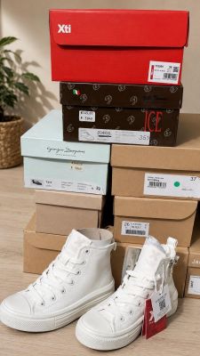 several boxes of shoes are stacked on top of each other on the floor