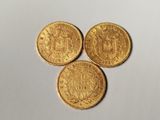 three gold sovereigns, one of which is a sovereign and the other of which is a sovereign