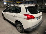 the rear end of a white car parked in a garage