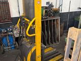 a fork lifter that is sitting in a garage