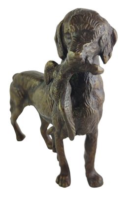 bronze statue of a dog holding a bird in its mouth