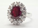 une bague ovale sertie d'un rubis et de diamants, entourée d'un bouquet de diamants blancs