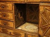 a wooden cabinet with drawers and a tiled floor