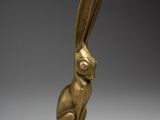 a bronze statue of a rabbit sitting on its hind legs