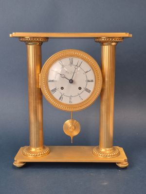 a gold clock that is sitting on a table