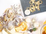 many different types of jewelry on a white table