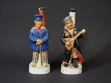 pair of ceramic figurines of two men playing musical instruments