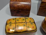 three boxes and a bowl sitting on a table