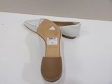 the shoe is white and has a brown sole