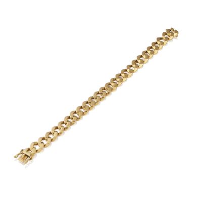 a close up of a gold bracelet on a white background