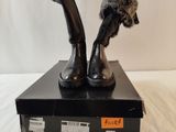 a statue of a person holding a microphone on top of a box