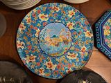 many plates on the table with a picture of a bird on them