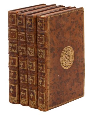 a set of four antique books sitting on top of each other