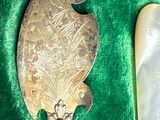 a silver spoon and a mirror on a green cloth