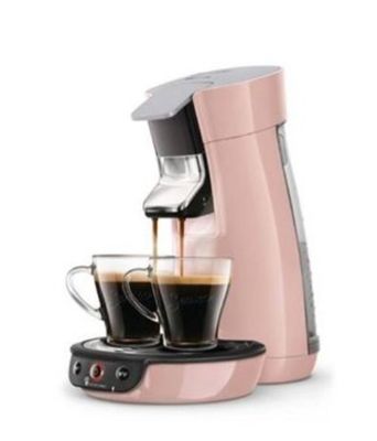 a pink coffee maker with two cups of coffee next to it