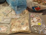 many bags of stamps on a table with a blue bag