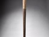 an old wooden baseball bat sitting on top of a white surface