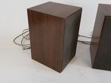 two speakers sitting next to each other on a white surface