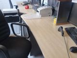 a computer desk with a keyboard and a monitor on it