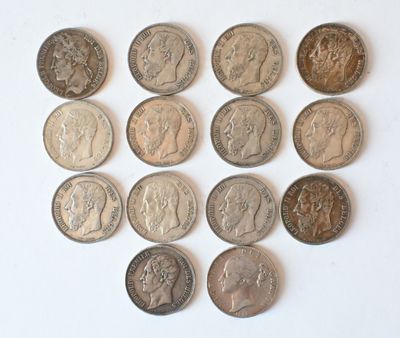 a lot of coins that are on a white surface