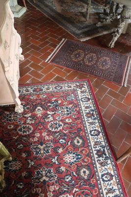 a rug on the floor next to a fireplace in a living room