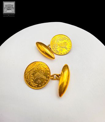 boutons de manchette plaqués or, ornés d'une pièce d'or sur un fond blanc