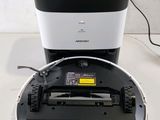 an image of a white and black robot sitting on top of a table