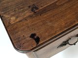 a small wooden table with a drawer on top of it