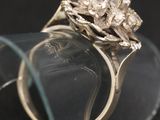 a close up of a diamond ring on a glass stand