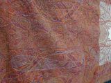 an image of a close up of a scarf hanging on a rack