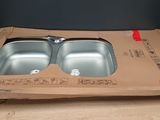 a cardboard box that has two sinks in it