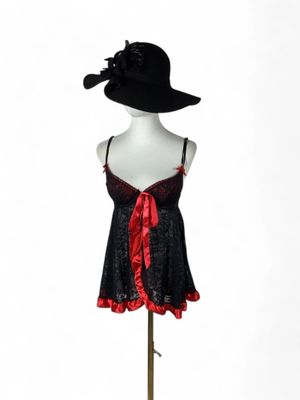 an image of a mannequin with a black hat and red ribbon