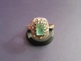 an image of a ring with a green stone in it