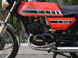 a red and black motorcycle parked on the side of the road