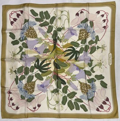 a close up of a square scarf with flowers and leaves on it