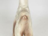 a small ceramic animal that is standing on a white surface