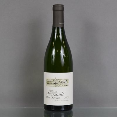 a bottle of wine sitting on a glass table
