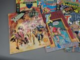 a lot of comic books sitting on a table