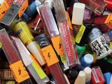 many different colors of lipsticks in a bin